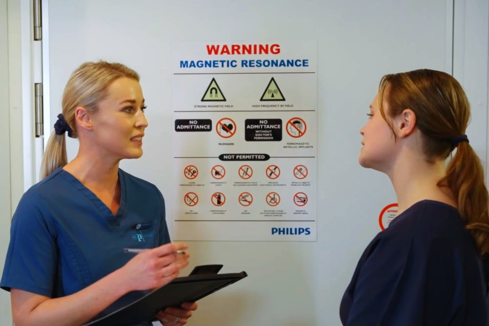 A radiographer asking a patient important safety questions before entering an MRI room at SCP Radiology.