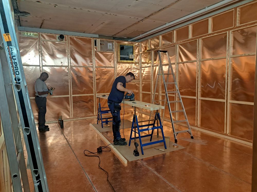 Finishing touches are applied to a Faraday cage, made from copper, before an MRI machine can be moved in.