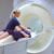 A radiographer preparing a patient for an MRI scan at SCP Radiology.